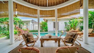 Deluxe Villa, Patio, Pool View | Living area