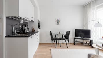 Basic Apartment, Courtyard View | Living area | 50-inch TV with cable channels