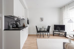 Basic Apartment, Courtyard View | Living area | 50-inch TV with cable channels - Modern 1BR Apartment in Kaleva (Tampere)