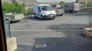 A parking lot with several vans and a trailer. - Apartment "Lune" RDC terrace, private parking (Saint-Julien-Chapteuil)