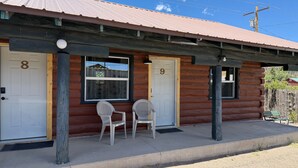 A log cabin with two doors, numbered 8 and 9, and two white plastic chairs on the porch. - Foothills Lodge 9 Suite - South Fork (South Fork)