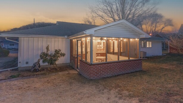 A single-story house with a covered porch and a brick foundation.