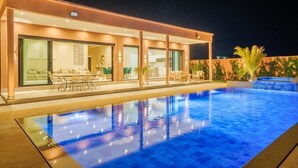 A modern building with a swimming pool, large windows, and outdoor seating. - VILLA YASMINA ( Not overlooked, heated pool) (Marrakech)