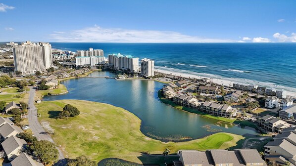 A coastal resort area with a large body of water, beachfront properties, and high-rise hotels.