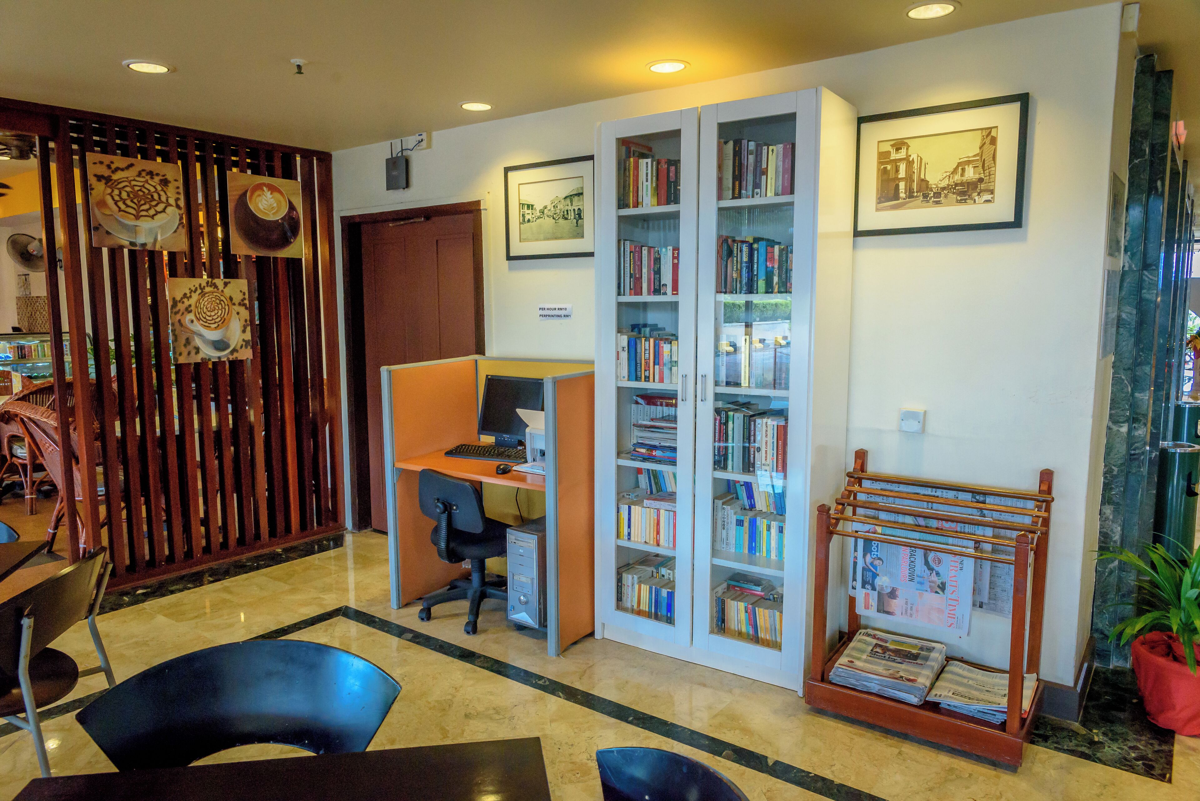 A library with bookshelves, a computer desk, and a magazine rack.