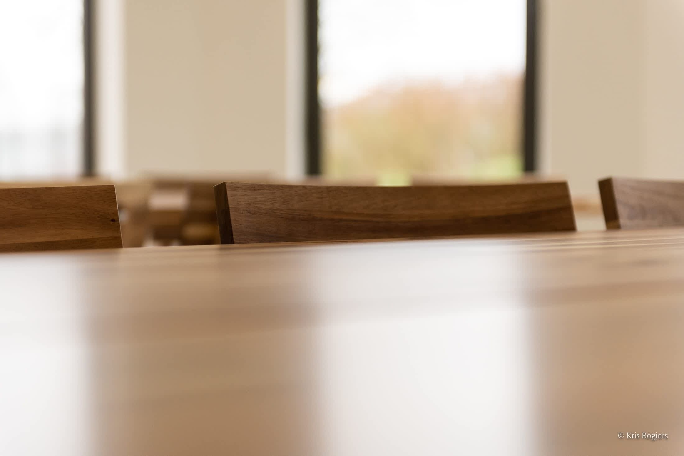 A wooden table with chairs.
