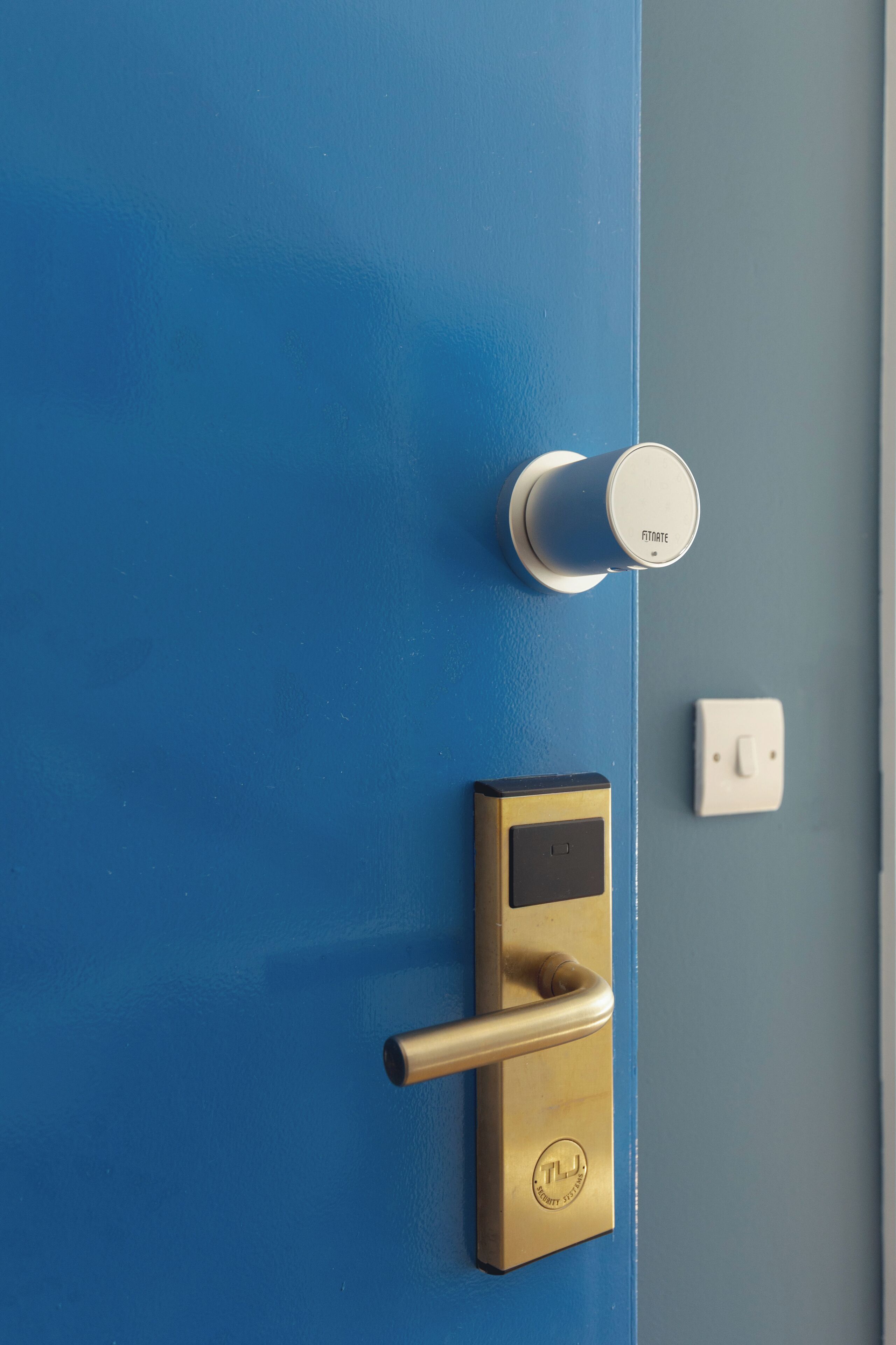 A blue door with a modern lock and a keyhole.