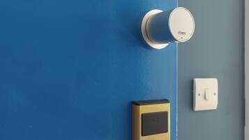 A blue door with a modern lock and a keyhole.