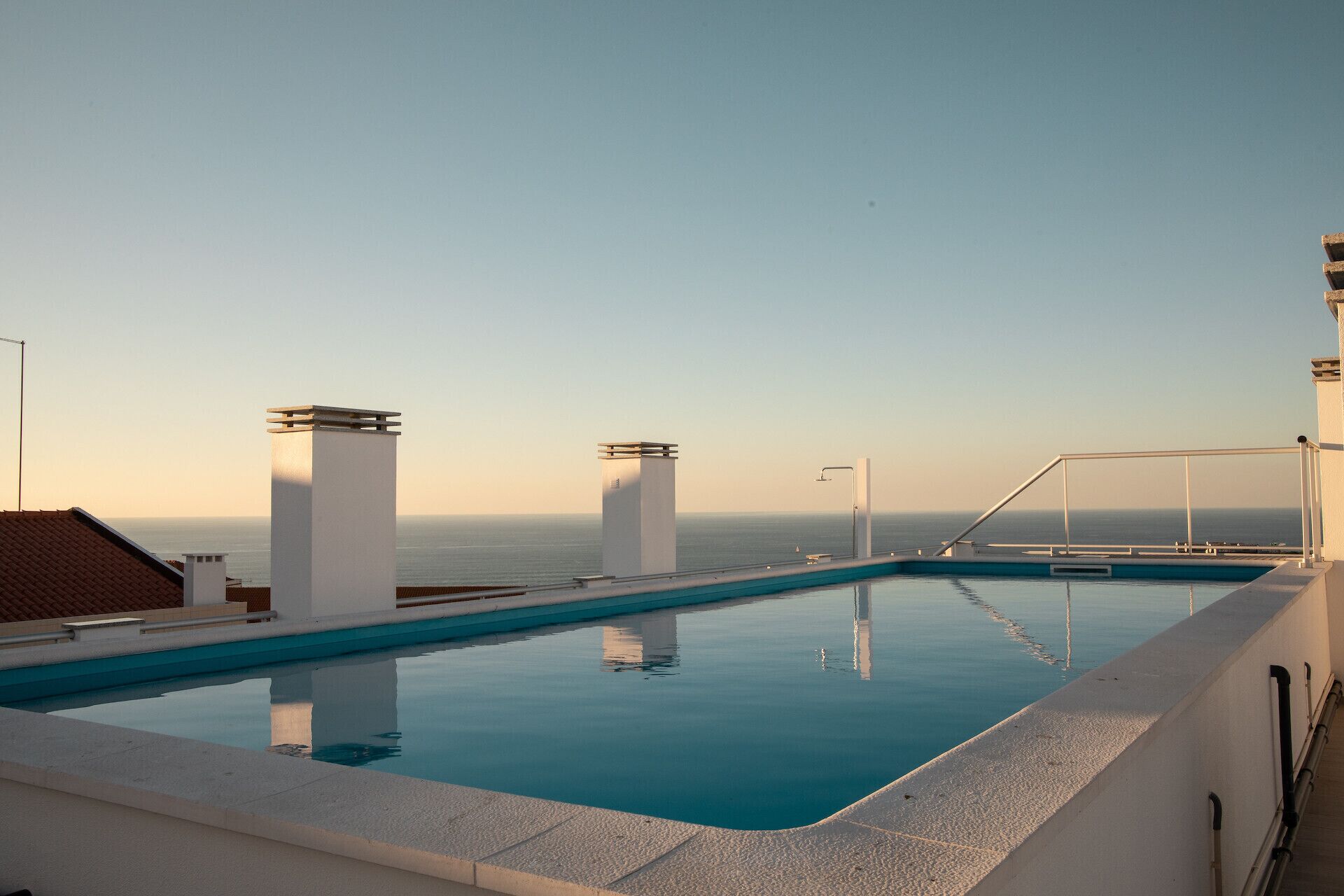 A rooftop pool with a clear view of the ocean.