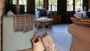 A cozy room with a sofa, a small round table with cups and saucers, and a wicker basket. - Escape to Nature in Vencimont (Gedinne)