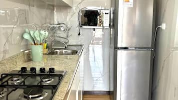 Comfort Apartment | Private kitchen | Full-size fridge, microwave, stovetop, cookware/dishes/utensils