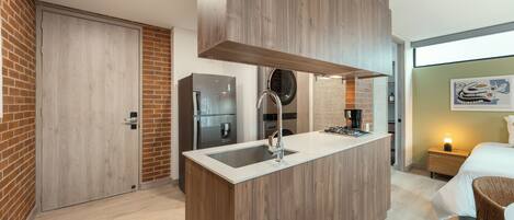 A modern kitchen with a built-in island, stainless steel appliances, and a brick accent wall.