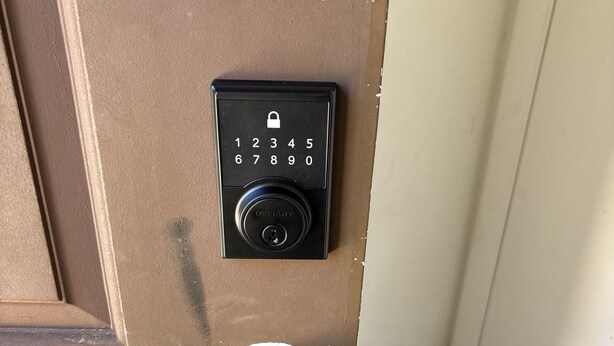 A door with a numeric keypad lock and a keyhole.