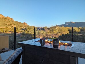 A patio with a fire feature, two mugs, and a view of a mountainous landscape. - Breathtaking Superstition views,  2-bedroom 2br golf course oasis, Gold Canyon (Gold Canyon)