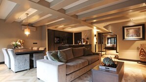 A modern living room with a sofa, chairs, a coffee table, and a dining area. - Luxury, Newly Remodeled Apartment in 16th Century Warehouse, with 10 meter Boat. (amsterdam)