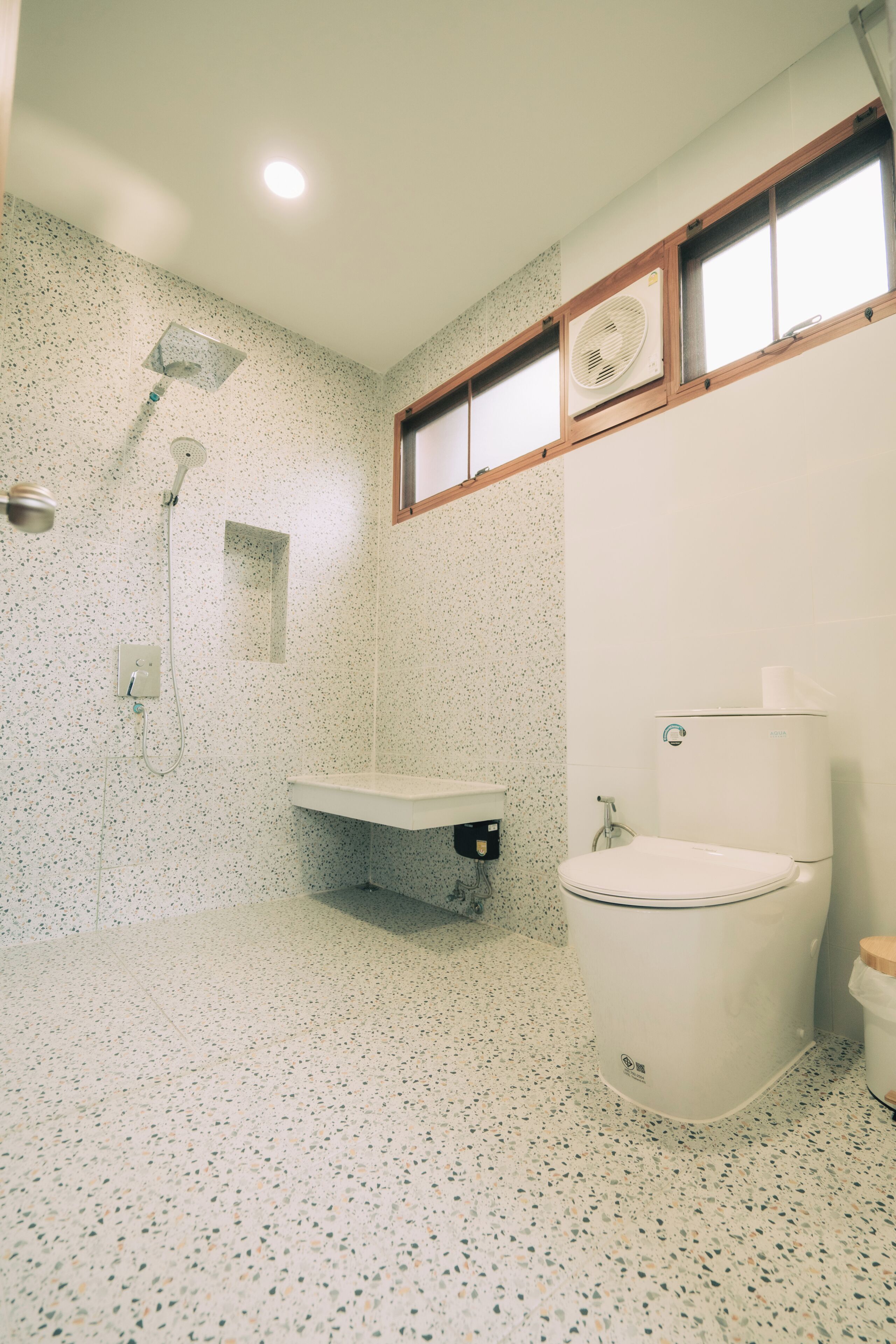 A bathroom with a shower, toilet, and sink.