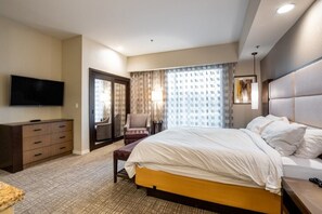 Relax in comfort with a large bed, flat-screen TV, and desk area.