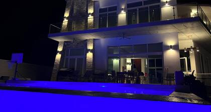 Spacious 5-bedroom house steps from beach in gated community with AC, WiFi