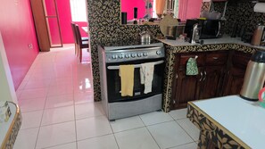 A kitchen with a stove, oven, and various appliances. - Relax & Unwind in Our Tranquil Space at Jamaica b&b rentals (Montego Bay)