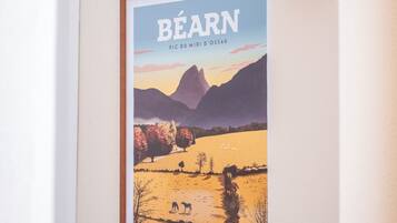 A framed picture of a landscape with mountains and trees, titled "Béarn."