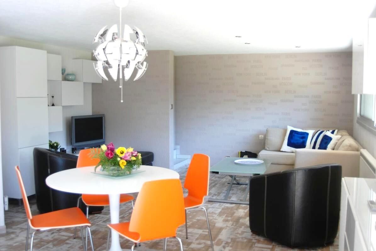 A modern living room with a sofa, a coffee table, and a TV.