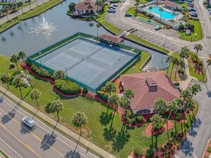 An aerial view of a property with a tennis court, a swimming pool, and a parking lot. - 1-Min to Beach – Hot Tub + Pickleball (St. Augustine)