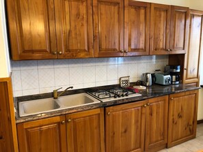 Fridge, microwave, stovetop, coffee/tea maker