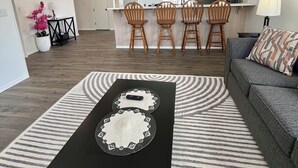 A modern apartment with a dining area, kitchen, and living room.