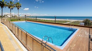 A swimming pool with a view of the beach and ocean.