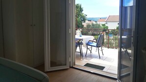 A room with a sliding glass door leading to an outdoor patio area.