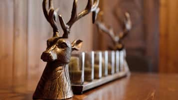A wooden deer head and antlers on a shelf.
