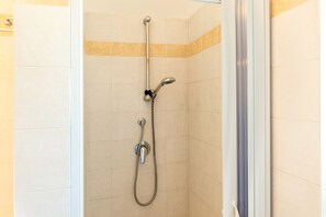A shower with a handheld showerhead and a wall-mounted faucet. - Apartment 'Camelia' with Shared Pool, Wi-Fi and Air Conditioning (Ceglie Messapica)