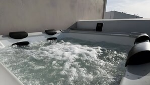A hot tub with water jets, a white wall, and a clear sky. - St George Sea View Double Room – Private Jacuzzi with Sea View (Santorini)