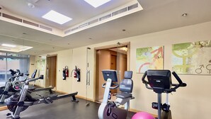 A gym with cardio machines, a mirror, and exercise balls. - 1BR Apt in Prime Location w/ Marina View Balcony (Dubai)