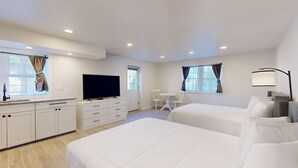 A hotel room with two beds, a TV, a desk, and a chair. - Comfortable Coastal Retreat with Two Queen Beds - Suite Room (Cape May)