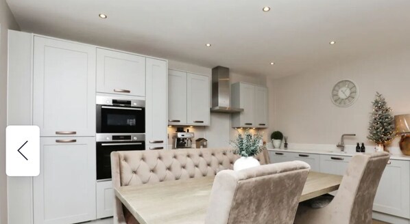 Enjoy cooking in this well-equipped kitchen with a microwave, oven, and dining area.