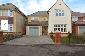 Stylish residential building with a central garage door and charming front garden.