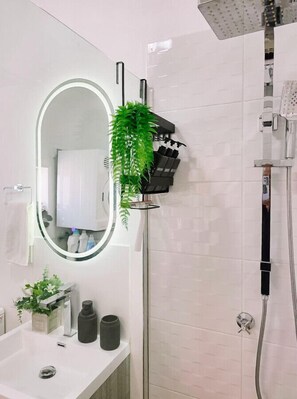 Shower, hair dryer, towels, soap