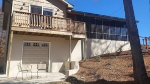 A two-story house with a balcony, a garage, and a large window. - Catfish Cove at Watts bar Lake (Rockwood)