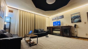 A modern living room with a sofa, a coffee table, and a fireplace.