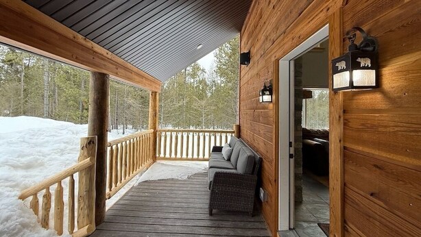 A wooden deck with a sofa and a bench, a wooden railing, and a door leading inside. - 30 Mins from YNP -Trail Access-Three Little Bears (Island Park)