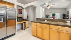 A modern kitchen with stainless steel appliances, wooden cabinets, and granite countertops. - Hidden Gem in La Quinta Cove with saltwater pool and spa, close to old town LQ (La Quinta)