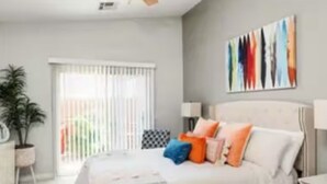 A bedroom with a bed, a ceiling fan, a window with blinds, a potted plant, and a painting on the wall. - Hidden Gem in La Quinta Cove with saltwater pool and spa, close to old town LQ (La Quinta)