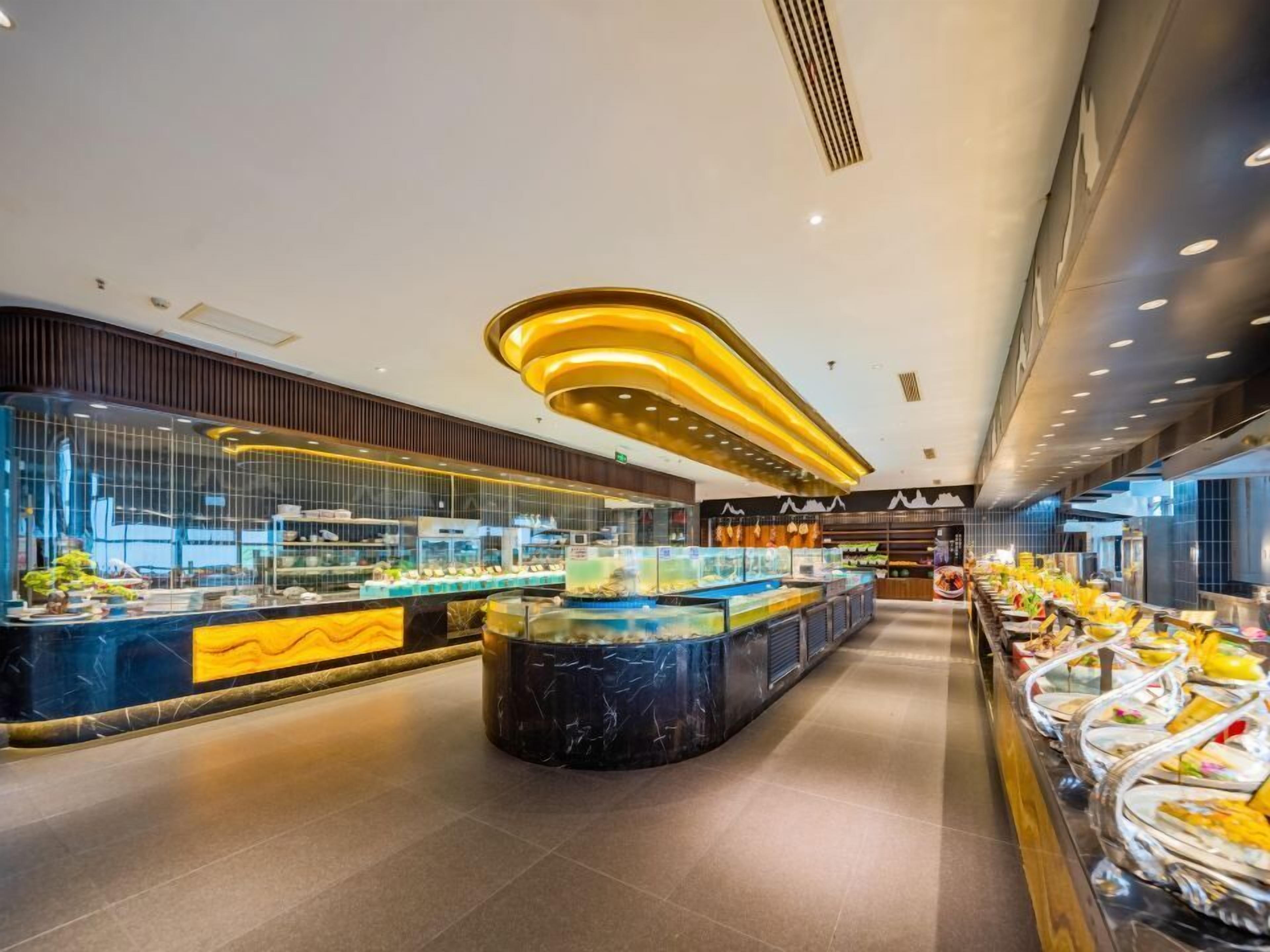 A modern buffet with a central marble island and glass display cases.