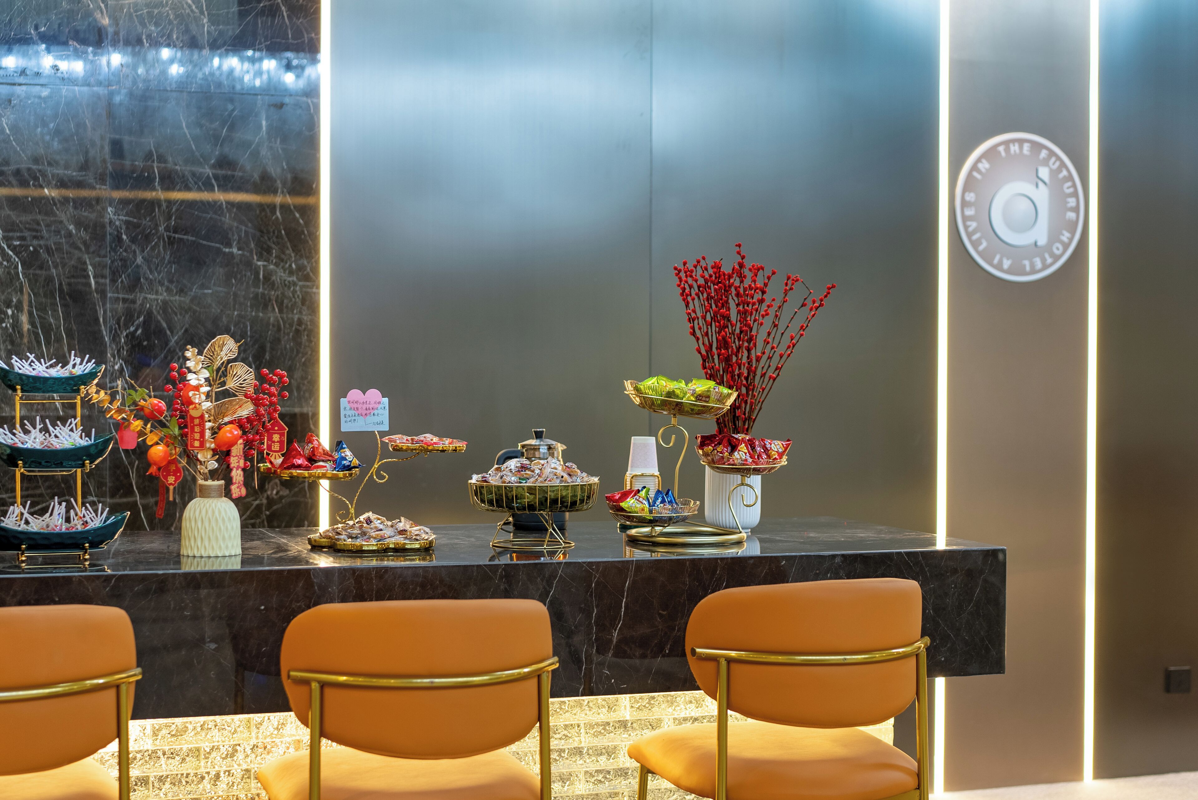 A reception area with a marble counter, decorative plants, and a clock on the wall.