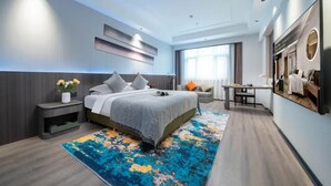 A modern hotel room with a large bed, a desk, and a view of the city. - AI Lives In The Future Hotel(Xi'an Longshouyuan Daming Palace West Subway Station Branch) (Xi'an)