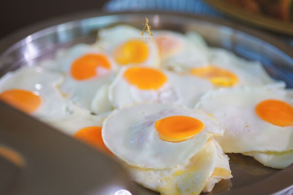 A plate with several sunny-side-up eggs. - Anant Pura Resort (Bung Khong Long)