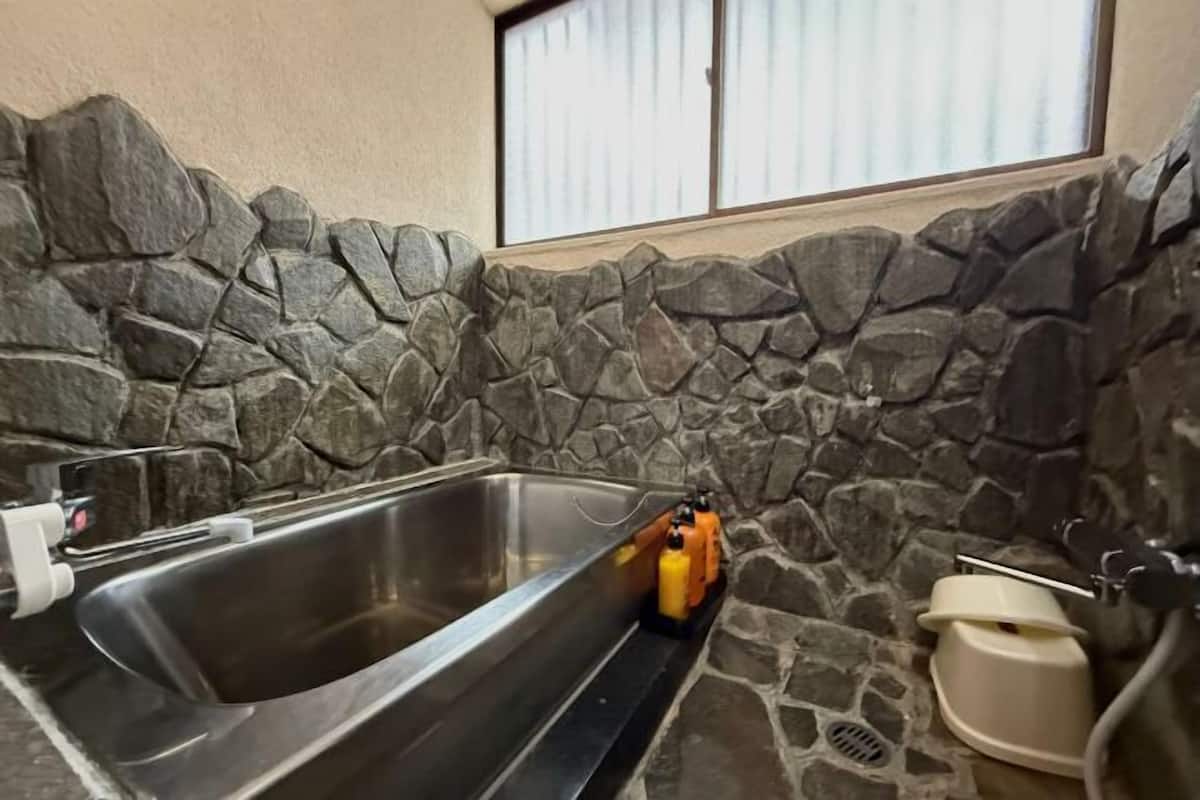 Separate bathtub and shower, hair dryer, towels, soap