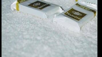 Four bars of soap on a textured surface.