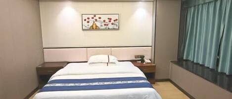 A hotel room with a bed, bedside table, nightstand, and a painting on the wall.